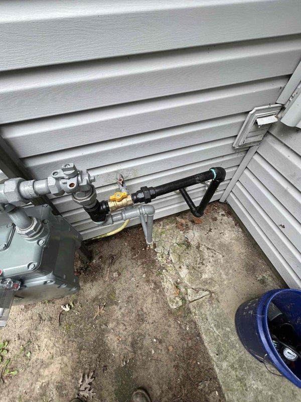 Performed warranty gas pressure test on recently installed natural gas meter and piping system. Inspected all connections, joints, and fittings including brass valve, rigid metal piping, and black flexible gas line connector. Verified system integrity and proper installation at exterior corner mounting location. Tested gas pressure levels to ensure compliance with manufacturer specifications and local code requirements. All components passed pressure test with no leaks detected. System confirmed operational and safe for continued use.