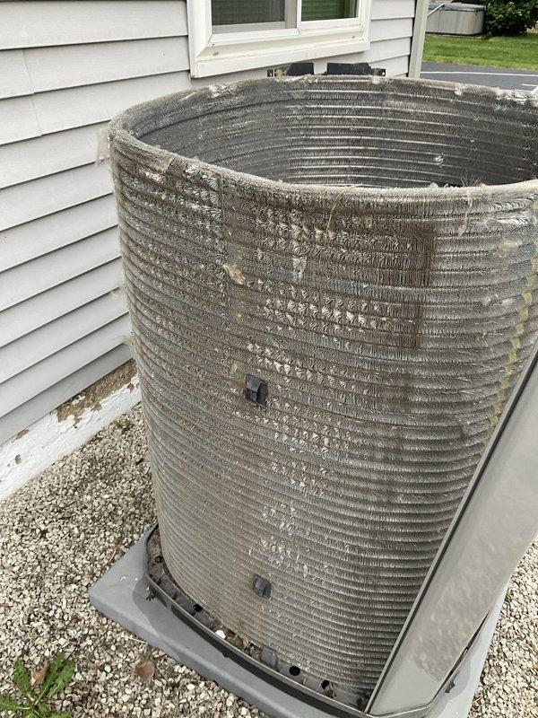 Completed scheduled HVAC maintenance agreement visit for tune-up service on residential air conditioning system with no reported issues. Upon arrival, found outdoor condensing unit with heavily soiled condenser coil fins showing significant accumulation of dust, dirt, and environmental debris blocking airflow passages throughout the coil surface. Performed comprehensive system inspection and cleaning, including thorough condenser coil cleaning to remove buildup and restore proper airflow through fins. Verified unit operation and system performance following maintenance procedures. System restored to optimal operating condition with improved heat transfer efficiency.