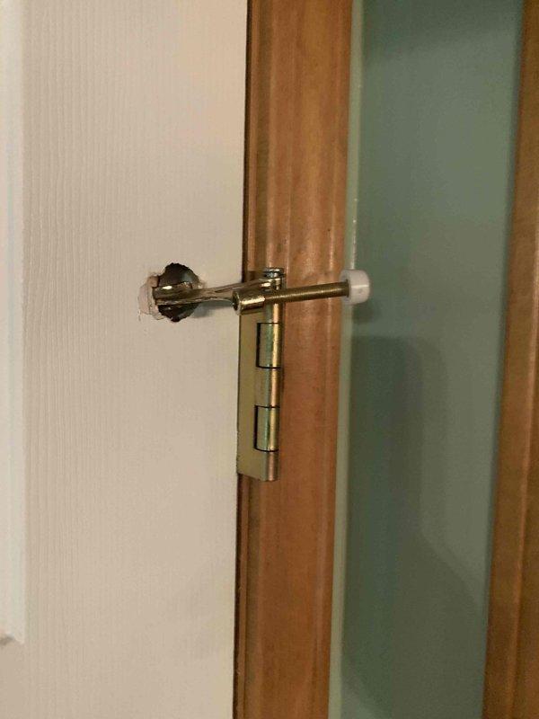 Responded to callback for door damage assessment on property with recent HVAC installation. Conducted thorough inspection of white six-panel interior door and surrounding wood trim to determine extent of damage and feasibility of in-house repair versus specialist referral. Documented door hardware including security chain latch, standard doorknob, and lever handle, all appearing functional. Photographed affected areas for records and determined damage scope falls outside HVAC service capabilities, recommending customer contact qualified door repair contractor for proper restoration.
