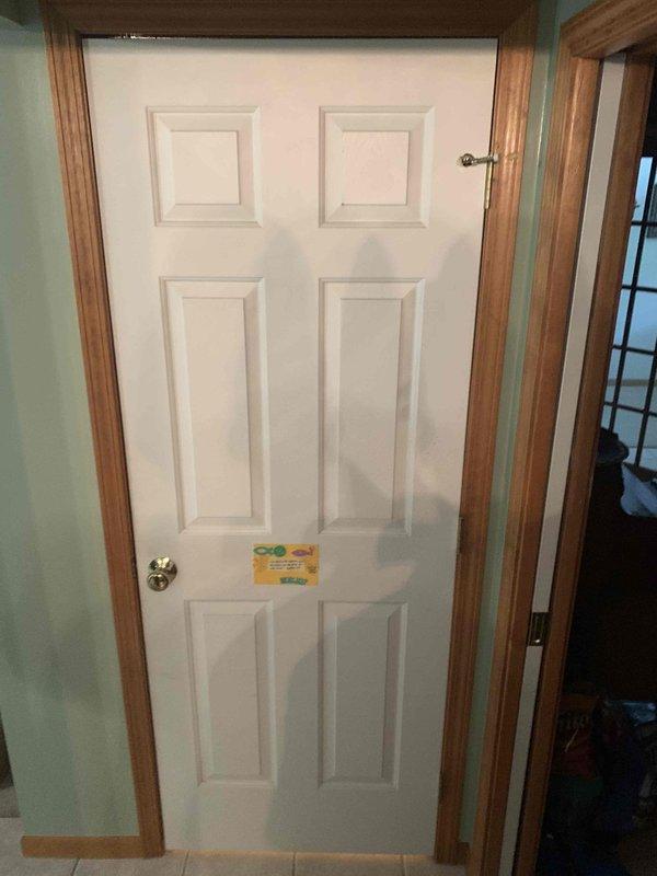 Responded to callback for door damage assessment on property with recent HVAC installation. Conducted thorough inspection of white six-panel interior door and surrounding wood trim to determine extent of damage and feasibility of in-house repair versus specialist referral. Documented door hardware including security chain latch, standard doorknob, and lever handle, all appearing functional. Photographed affected areas for records and determined damage scope falls outside HVAC service capabilities, recommending customer contact qualified door repair contractor for proper restoration.