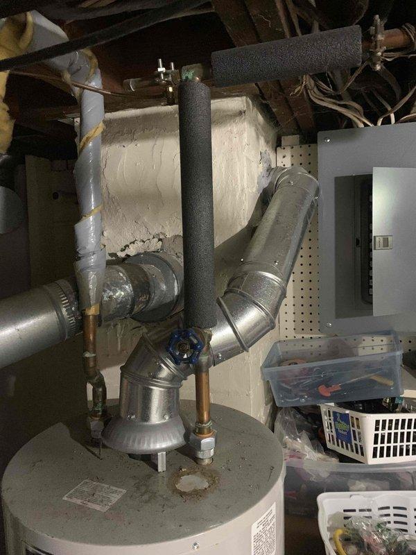Conducted comprehensive site assessment for Lennox system replacement under Feel the Love promotion, documenting existing equipment configuration and gathering critical measurements for proper sizing. Photographed current HVAC installation including outdoor condensing unit with weathered copper line set, indoor water heater with adjacent ductwork connections, and evaluated basement mechanical room layout to determine optimal equipment placement and verify clearance requirements for new system installation.