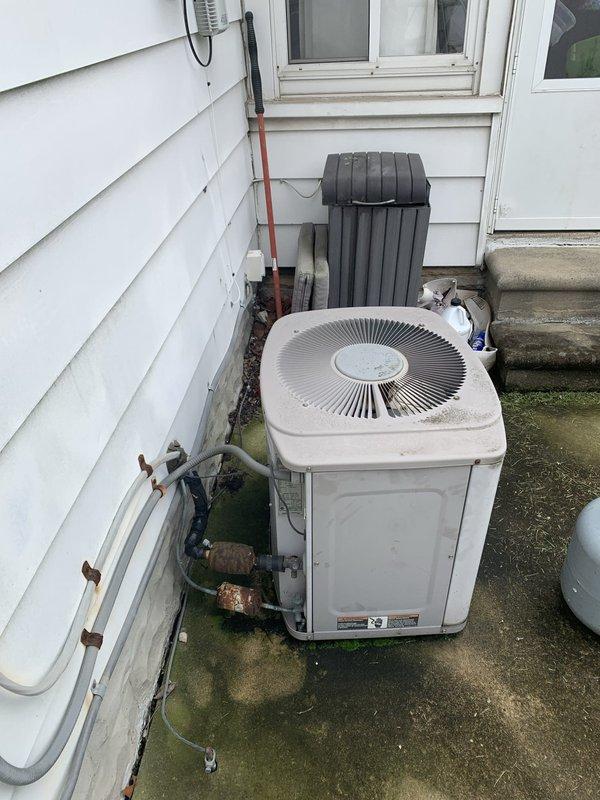 Conducted comprehensive site assessment for Lennox system replacement under Feel the Love promotion, documenting existing equipment configuration and gathering critical measurements for proper sizing. Photographed current HVAC installation including outdoor condensing unit with weathered copper line set, indoor water heater with adjacent ductwork connections, and evaluated basement mechanical room layout to determine optimal equipment placement and verify clearance requirements for new system installation.