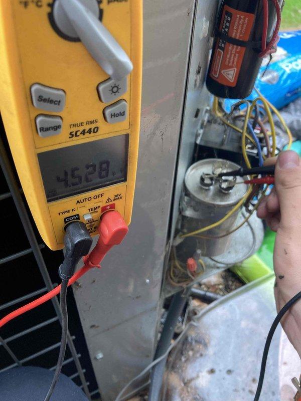 Completed club membership maintenance visit on residential AC system. Performed comprehensive electrical diagnostics using digital multimeter, recording voltage readings of 2528 on system components. Inspected and tested capacitor, motor connections, and associated wiring within outdoor condensing unit. Identified severely corroded heating elements requiring removal and evaluation, with components showing significant rust and oxidation throughout metal surfaces. All electrical measurements documented for system performance assessment.