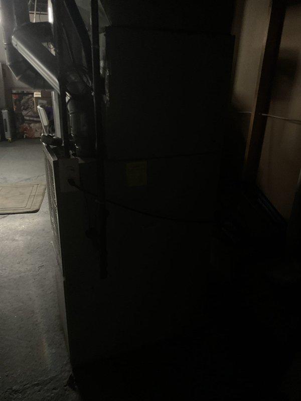 Conducted on-site evaluation of existing residential furnace system in basement utility area for replacement estimate. Inspected current beige/cream-colored furnace unit with associated ductwork, metal plenum, and vertical supply connections. Documented equipment condition, ductwork configuration, and installation space parameters through photographic assessment to provide accurate replacement recommendations and system specifications.