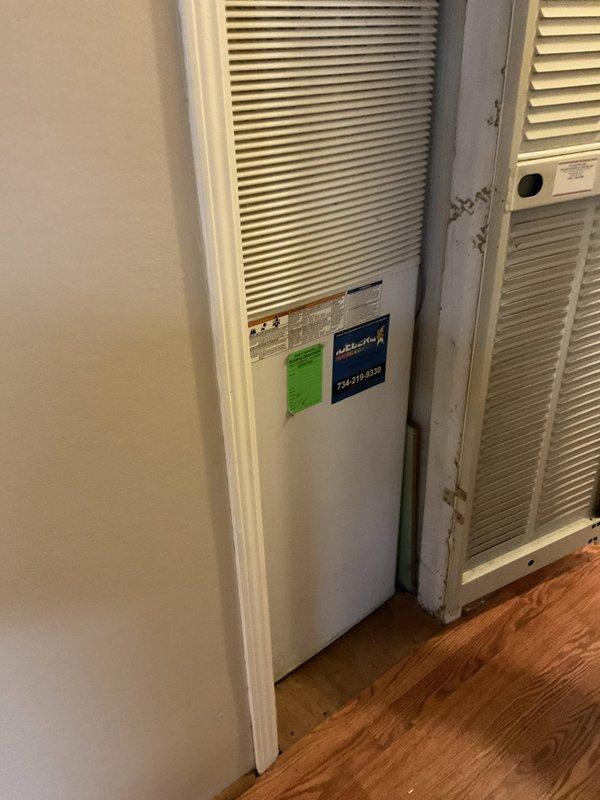 Conducted on-site evaluation of existing HVAC system for equipment replacement estimate. Documented current furnace/air handler unit installed in interior closet space with louvered doors, photographed manufacturer labels and model information for specification purposes. Assessed mechanical space configuration including aged cylindrical expansion tank in ceiling cavity and return air grille with 16x20x1 filter dimension. Gathered necessary equipment data and system specifications to prepare comprehensive replacement proposal.