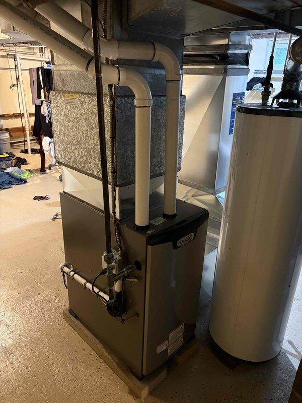Completed full furnace installation including mechanical and electrical connections in basement mechanical room. Installed new high-efficiency furnace unit with proper PVC venting system routed vertically through structure, connected humidifier to copper supply line with shutoff valve in upper level, and reconnected all ductwork to existing plenum. All components tested and operational upon completion.