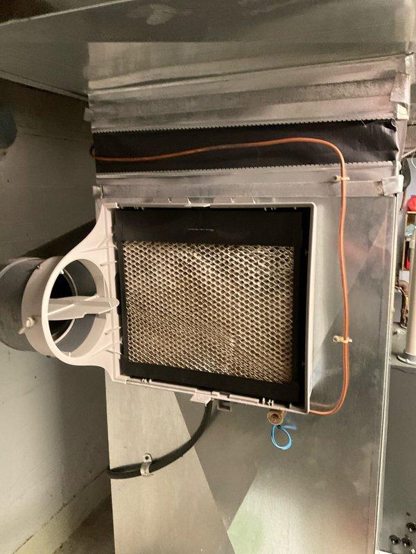 Completed scheduled maintenance agreement visit for air handler and system inspection under Club Heat8-12 program. Performed comprehensive inspection of HVAC air handler components including return air filter housing, ductwork connections, and refrigerant lines. Verified proper installation and condition of white plastic-framed filter housing with mesh metal filter, confirming adequate airflow through return air system. Inspected flexible duct connections, copper refrigerant tubing, and electrical wiring for secure mounting and proper operation. Documented system conditions through photographs showing filter assembly, duct connections, and associated components within mechanical room installation. All components found operating within normal parameters with no immediate service needs identified. System tagged and ready for continued operation.