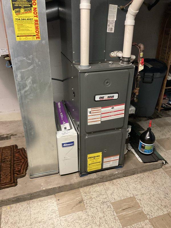 Responded to service call for failed heat exchanger evaluation on residential furnace system. Performed comprehensive inspection of existing HVAC equipment, including gray metal furnace unit with white PVC venting and associated ductwork in basement utility area. Documented current system configuration with detailed photographs showing furnace condition, venting arrangement, refrigerant line routing, and surrounding mechanical components. Assessed heat exchanger failure and provided estimate for replacement options to restore safe heating operation.