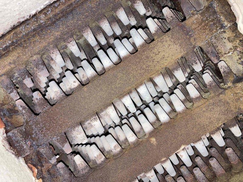 Completed preventive maintenance inspection on air handler as part of Club membership agreement. Upon inspection, discovered severely deteriorated heat exchanger assembly with extensive corrosion, rust discoloration, and heavy mineral deposits throughout multiple fin sections. The component exhibited advanced oxidation with white crystalline scale buildup, indicating prolonged moisture exposure and compromised system integrity. Removed and documented corroded evaporator coil section for replacement recommendation. Photographed condition of deteriorated components showing widespread pitting and scaling across all fin banks. System requires immediate attention due to safety concerns and reduced heating efficiency from compromised heat exchanger integrity.