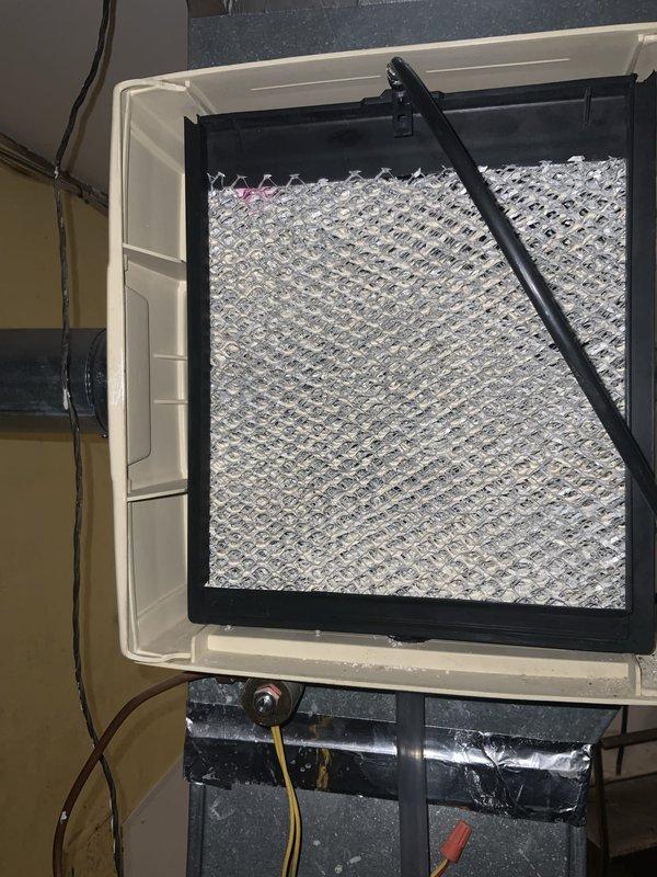 Performed annual maintenance tune-up on 22-year-old furnace system under club membership agreement. Upon arrival, addressed customer concern regarding furnace not shutting off properly and inspected filter per customer request due to concerns about clogging. Discovered air filter completely covered in heavy frost and ice buildup, indicating severe airflow restriction and potential system cycling issues. Removed heavily frosted filter from rear access point and replaced with new pleated filter. Frost accumulation on original filter confirmed restricted airflow was likely causing the furnace to run continuously as system struggled to reach temperature setpoint. Also addressed customer concern regarding black material appearing in water pipes when system is filled, which may indicate sediment buildup in hydronic components. Completed full system inspection and tune-up procedures. Documented conditions with photos showing extent of frost buildup on removed filter and new replacement filter