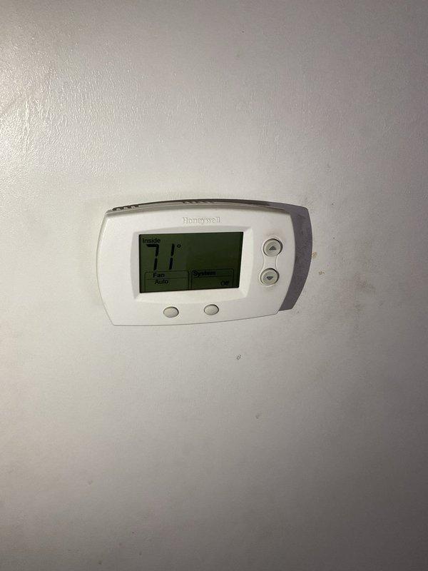 Performed on-site evaluation of 19-year-old furnace system with failed inducer motor. Documented existing equipment condition including thermostat operation and internal cabinet components showing significant frost accumulation indicative of airflow restrictions or refrigerant issues. Provided comprehensive replacement estimate for furnace system due to age of unit and cost-effectiveness of full replacement versus component repair on aging equipment.