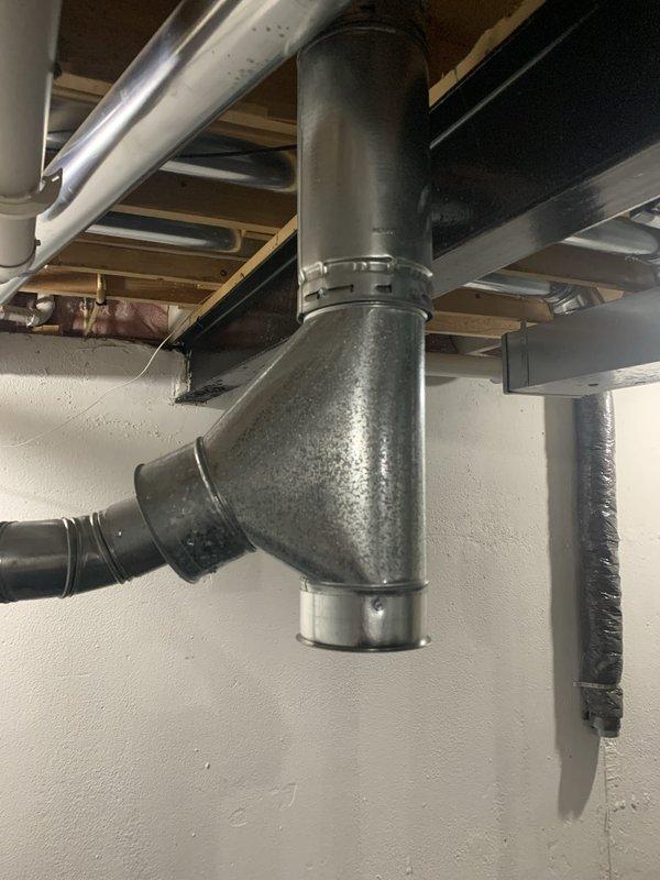 Successfully installed a new 110,000 BTU furnace in the basement utility area with complete mechanical hookup. Configured and connected white PVC venting system with proper routing and support, reconnected all electrical components including conduit and wiring, and integrated condensate pump for drainage. The furnace was positioned adjacent to the existing water heater with proper clearances maintained, all ductwork connections were secured at the plenum junction, and the system was tested for proper operation upon completion.
