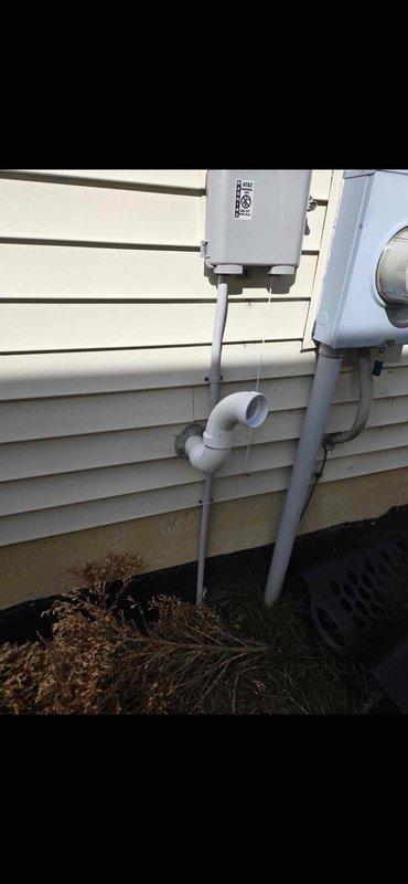 Completed full installation of 70,000 BTU furnace with mechanical and electrical connections, including humidifier integration and electrical reconnection. Installed exterior PVC venting system with proper termination through building wall and mounted electrical disconnect box on exterior siding. Positioned new furnace unit in basement utility area adjacent to existing water heater, secured within wooden chase, and verified all ductwork connections and condensate drainage systems are operational.