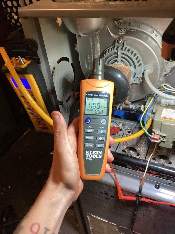 # HVAC Service Completed

Responded to no heat call on furnace over 10 years old with reported flame rollout and abnormal operating noise. Upon arrival, confirmed furnace was short cycling with ignition followed by immediate flame extinguishment while blower continued to run. Performed comprehensive diagnostic testing of heating system including combustion analysis and safety device inspection.

Utilized digital multimeter and carbon monoxide testing equipment to assess system operation and verify safe combustion conditions. CO readings confirmed at 0.00 ppm in ambient air around unit. Inspected burner assembly, flame sensor, gas valve operation, and ignition sequence. Examined blower motor assembly and verified electrical connections throughout system. Identified intermittent flame failure condition requiring component replacement and system recalibration.

System restored to proper operation with normal ignition sequence and stable flame. Verified all safety controls functioning corr