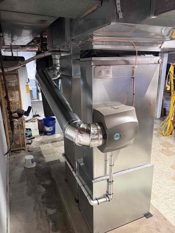 Completed full HVAC system installation including 70,000 BTU furnace and 2.5-ton air conditioning unit positioned in right side yard. Performed all mechanical and electrical connections per manufacturer specifications. Installed humidifier integration with furnace system. Reconnected all existing ductwork to new equipment with proper sealing and insulation at connection points. Ran copper refrigerant lines from outdoor condenser to indoor air handler. Installed and programmed digital thermostat for system control. Verified proper airflow, refrigerant charge, and electrical connections. Tested complete system operation including heating, cooling, and humidification functions. All equipment operational and ready for service.