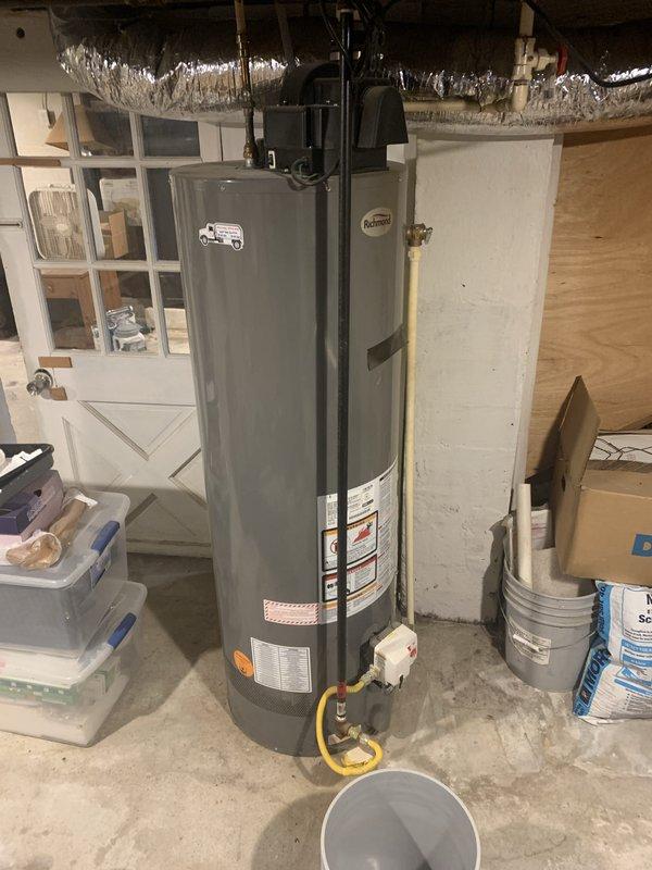 Completed full HVAC system installation in residential basement consisting of 70,000 BTU Lennox furnace and 2-ton air conditioning unit configured for right-side discharge. Installed furnace on concrete pad with proper clearances and connected to existing ductwork system using rigid and flexible metal ducting. Ran yellow gas supply line to furnace with appropriate shutoff valve and made all necessary gas connections per code. Installed condensate drainage piping and connected electrical supply. Mounted AC evaporator coil and completed refrigerant line connections between indoor and outdoor units. Verified all duct connections were properly sealed and secured. Connected humidifier system to water supply and furnace with visible piping along left side of unit. Tested all system operations including heating cycle, cooling cycle, airflow, and safety controls. Confirmed proper ignition sequence, flame characteristics, and temperature rise across heat exchanger. Verified refrigerant charge a