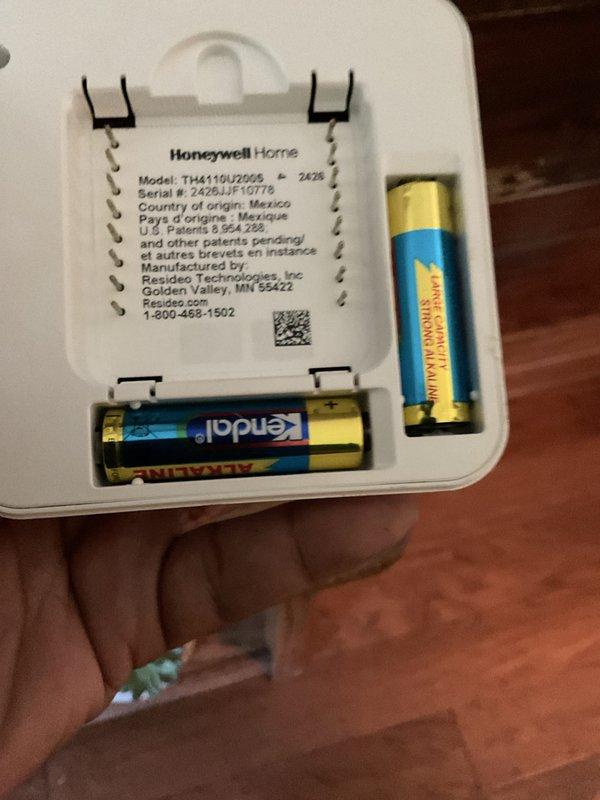 Completed annual HVAC maintenance tune-up as part of scheduled club membership visit with no reported issues from customer. Inspected and serviced air handler unit, documenting equipment specifications and verifying proper operation of all mechanical and electrical components. Identified corroded batteries in Honeywell Home thermostat model TH4110U2005 showing visible leakage and crystalline buildup on terminals; replaced batteries to ensure continued reliable thermostat operation and system control.