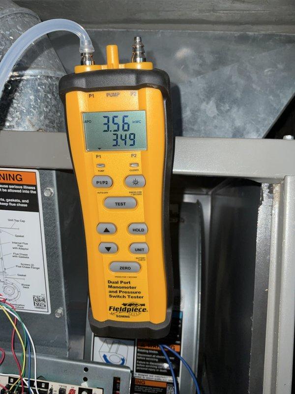 Responded to service call for heating system producing vibration noise after recent blower motor replacement. Performed comprehensive heating maintenance and system diagnostics. Inspected 20x25x4 air filter and verified proper installation in air handler unit. Conducted pressure differential testing using digital manometer, measuring static pressures at 356 and 349 inches water column to assess airflow restrictions and system performance. Evaluated blower assembly operation, ductwork connections, and identified source of vibration. System tuned and adjusted to restore proper heating operation.