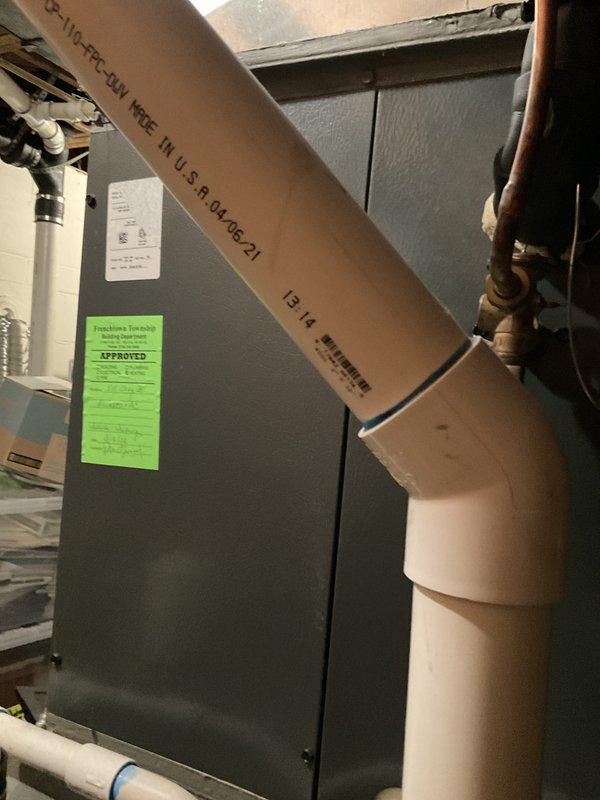 Performed comprehensive tune-up on residential furnace and air handler system. Completed full inspection of all mechanical components, verified proper operation of blower motor and heat exchanger, checked all electrical connections, tested safety controls, and inspected venting system including PVC exhaust piping. System found to be operating within normal parameters with no issues identified; green approval tag affixed to unit confirming satisfactory completion of maintenance service.