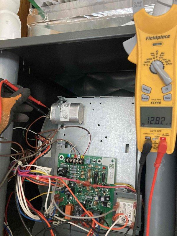 Completed seasonal maintenance agreement visit for AC and furnace system. Performed comprehensive diagnostics on HVAC control board using Fieldpiece SC440 multimeter, measuring electrical parameters including voltage readings of 12.82V and 5.07V at various test points to verify proper system operation. Inspected control board components, capacitor, and wiring connections to ensure all electrical systems were functioning within manufacturer specifications.