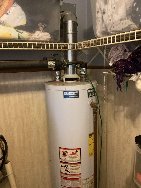 Provided estimate for replacement of non-functional Kenmore PowerMister standard water heater in residential utility closet. Existing unit is a natural draft model requiring standard replacement installation. Assessed current plumbing connections, gas supply lines, and venting configuration to determine scope of work for new water heater installation.