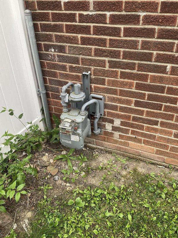 Conducted on-site evaluation for HVAC system replacement estimate on 26-year-old equipment utilizing natural gas fuel source. Assessed existing furnace and related components located in basement utility area, documented current system configuration including gas meter installation, venting arrangement, and electrical connections to provide comprehensive replacement specifications for comfort advisor consultation.