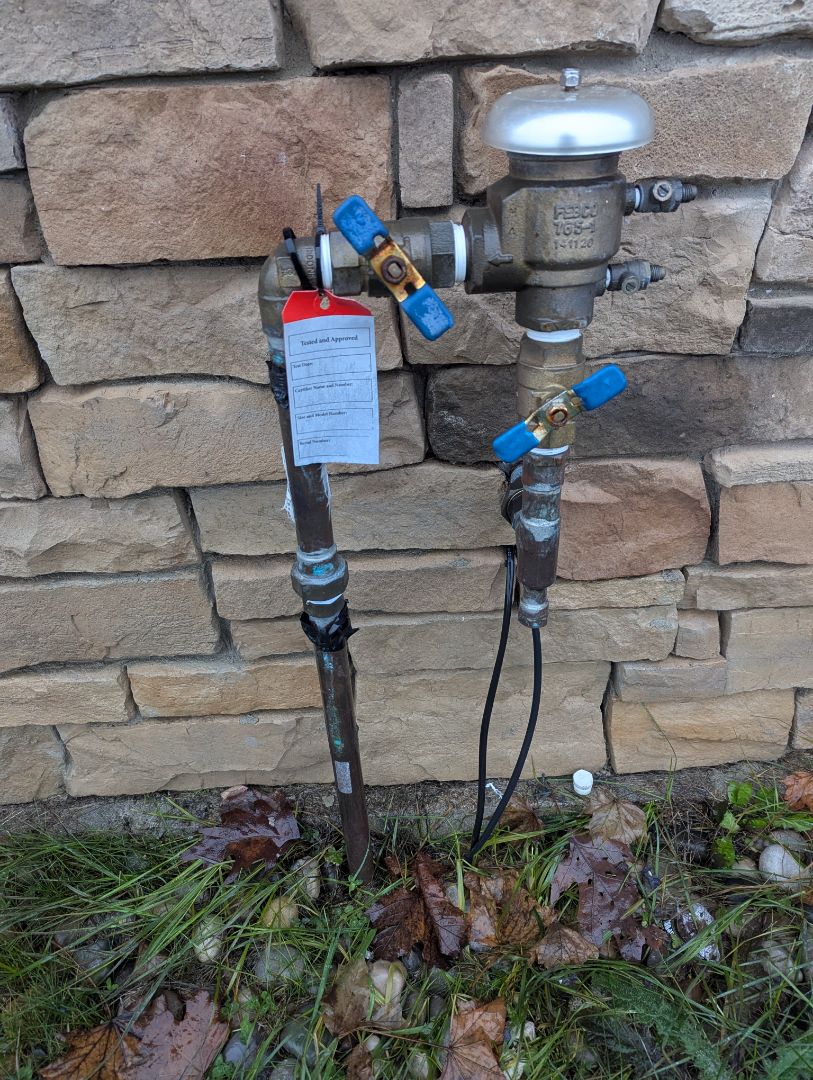 turn water off to irrigation system inside. building and drain down water on leaking pressure vacuum breaker outside.