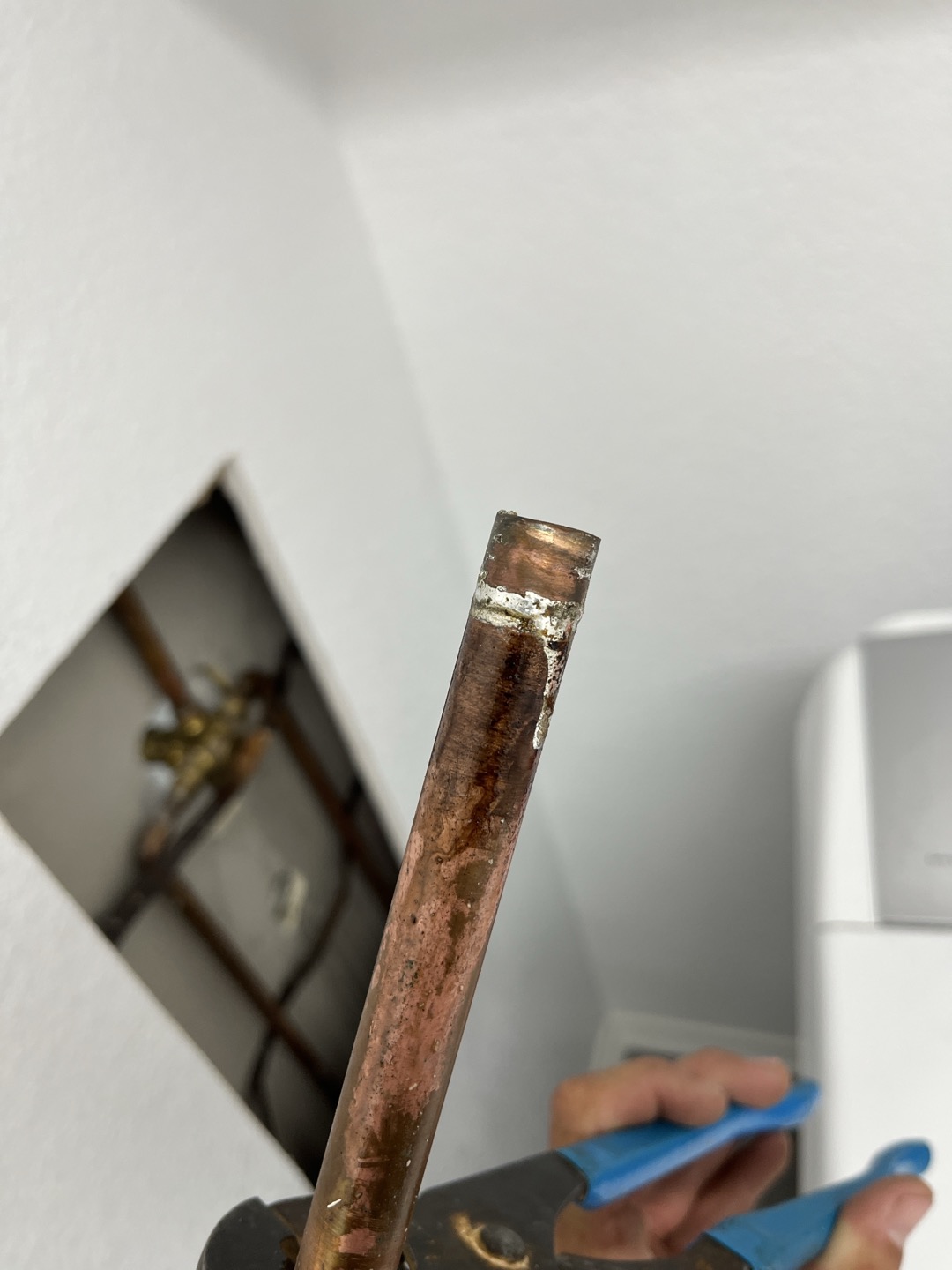 Customer had water damage to ceiling above dinning room table. Opened ceiling to inspect for leak and found that leak was coming from behind shower valve. Proceeded to open drywall in laundryroom to expose valve for secondary bathroom. Ran water and found that the copper line tying into bottom of shower valve was not properly soldered and was leaking. Removed section and re soldered. Also re tightened loose shower head arm. Ran water in bathroom for several minutes and didn’t see any further leaks. 