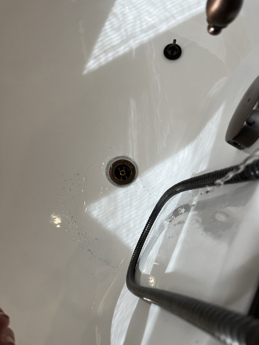 Customer complained of no pressure to master bathroom bathtub and laundry room faucet. Was able to restore pressure to both fixtures by disassembling supply lines and cartridges and flushing of system. Fixtures had large amounts of mineral deposits clogging water lines 