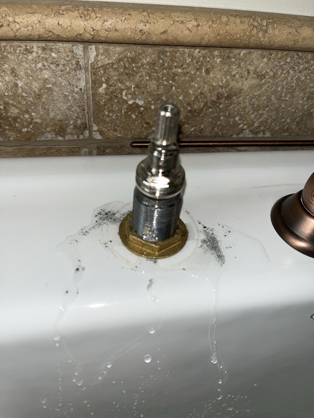 Customer complained of no pressure to master bathroom bathtub and laundry room faucet. Was able to restore pressure to both fixtures by disassembling supply lines and cartridges and flushing of system. Fixtures had large amounts of mineral deposits clogging water lines 
