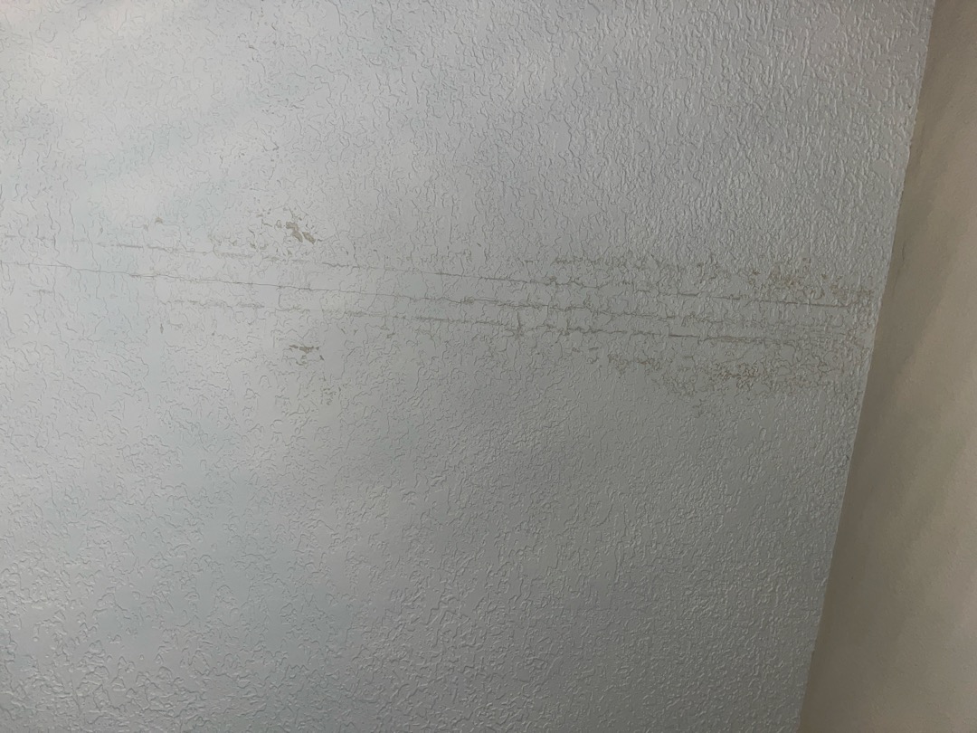 Customers had drywall damage to master bedroom as a result of a roof leak that has already been repaired. Damage is mostly isolated to ceiling and drywall surrounding window. 