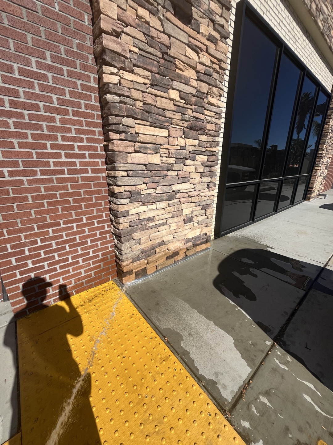 Customer complained of water coming out under exterior wall. Performed inspection  of plumbing and ruled out any plumbing leaks. Performed flood test to exterior wall and found that water was entering behind exterior light mounted on wall. Recommend sealing around light and performing flood test again to ensure there are no other areas where water can seep through 