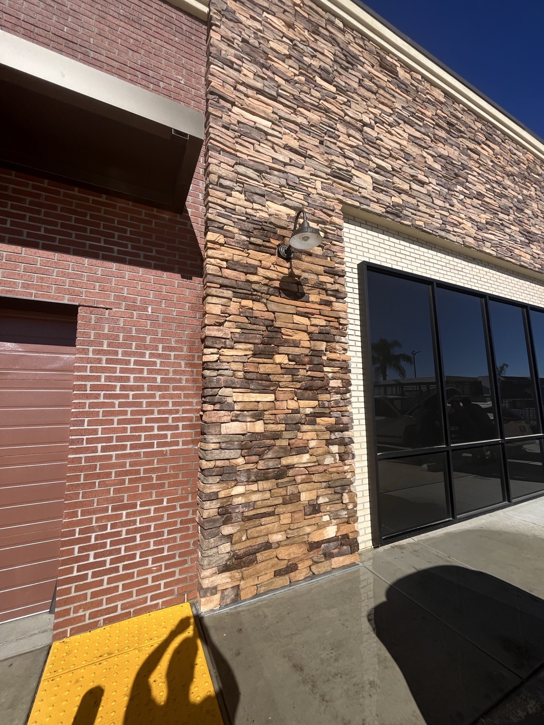 Customer complained of water coming out under exterior wall. Performed inspection  of plumbing and ruled out any plumbing leaks. Performed flood test to exterior wall and found that water was entering behind exterior light mounted on wall. Recommend sealing around light and performing flood test again to ensure there are no other areas where water can seep through 