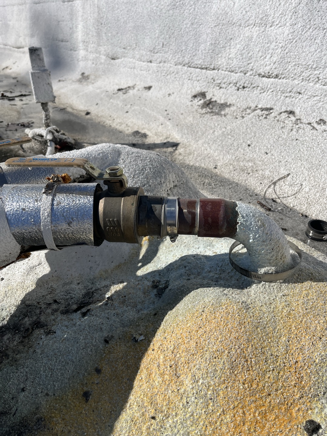 Upon arrival I found customer has a pin hole leak in their existing copper pipe right before it entered down into the unit. We previously replaced approximately 40’ of copper pipe on the roof up until where the shut off valve is seen in the photo. Due to the previous history of issues on this section of piping I recommend replacement of pipe from 90 located at the roof all the way down to where the pine ties into the circulating pump. This run is approximately 20’ in length. In order to perform replacement we will need to remove the water proofing located around the pipe to remove the old pipe and install the new pipe. We can attempt to add new sealant around protrusion through roof but recommend having customers roofing contractor come out and properly seal. 