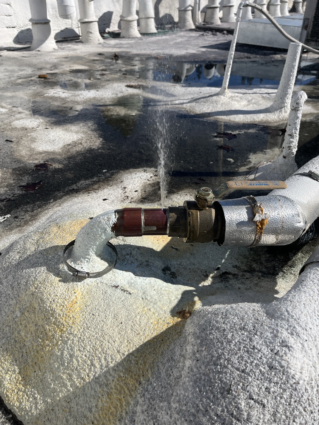 Upon arrival I found customer has a pin hole leak in their existing copper pipe right before it entered down into the unit. We previously replaced approximately 40’ of copper pipe on the roof up until where the shut off valve is seen in the photo. Due to the previous history of issues on this section of piping I recommend replacement of pipe from 90 located at the roof all the way down to where the pine ties into the circulating pump. This run is approximately 20’ in length. In order to perform replacement we will need to remove the water proofing located around the pipe to remove the old pipe and install the new pipe. We can attempt to add new sealant around protrusion through roof but recommend having customers roofing contractor come out and properly seal. 