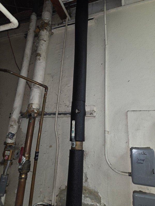 Responded to water leak in utility area. Inspected insulated black pipe system showing signs of water damage at connection points. Replaced damaged pipe fitting, resealed connections, and verified system integrity through pressure testing. All pipes now functioning properly with no signs of leakage.