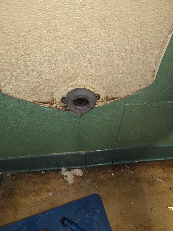 Inspected water heater exhibiting corrosion and deterioration at tank drain valve connection point. Documented signs of rust and possible water damage where the drain fitting meets the tank body. Photos taken to document current condition for future reference.