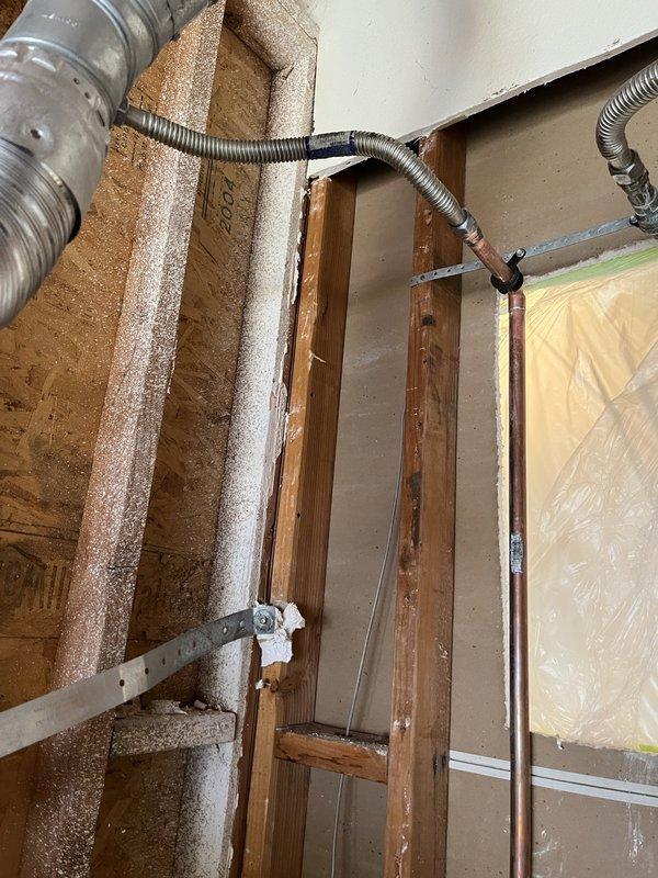 Performed inspection of crawlspace area revealing plumbing configuration with copper and PVC pipes. Identified and documented areas of water intrusion affecting wooden structural components including joists, beams, and OSB sheathing. Completed remediation work on exposed framing, installed new copper piping connections with properly soldered joints, and verified integrity of flexible metal conduit transitions. Moisture barriers were assessed and reinforced where necessary.