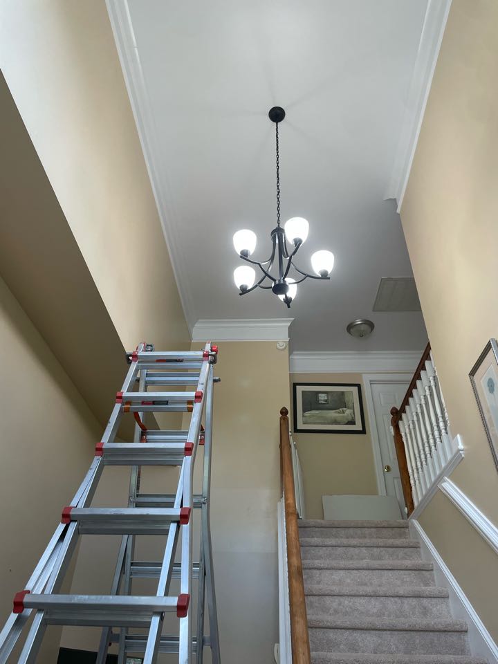 New Light fixture installation in the Raleigh, NC area. This light was installed in a 20 foot, high-ceiling, foyer room. Call Royal electric today for your free quote!