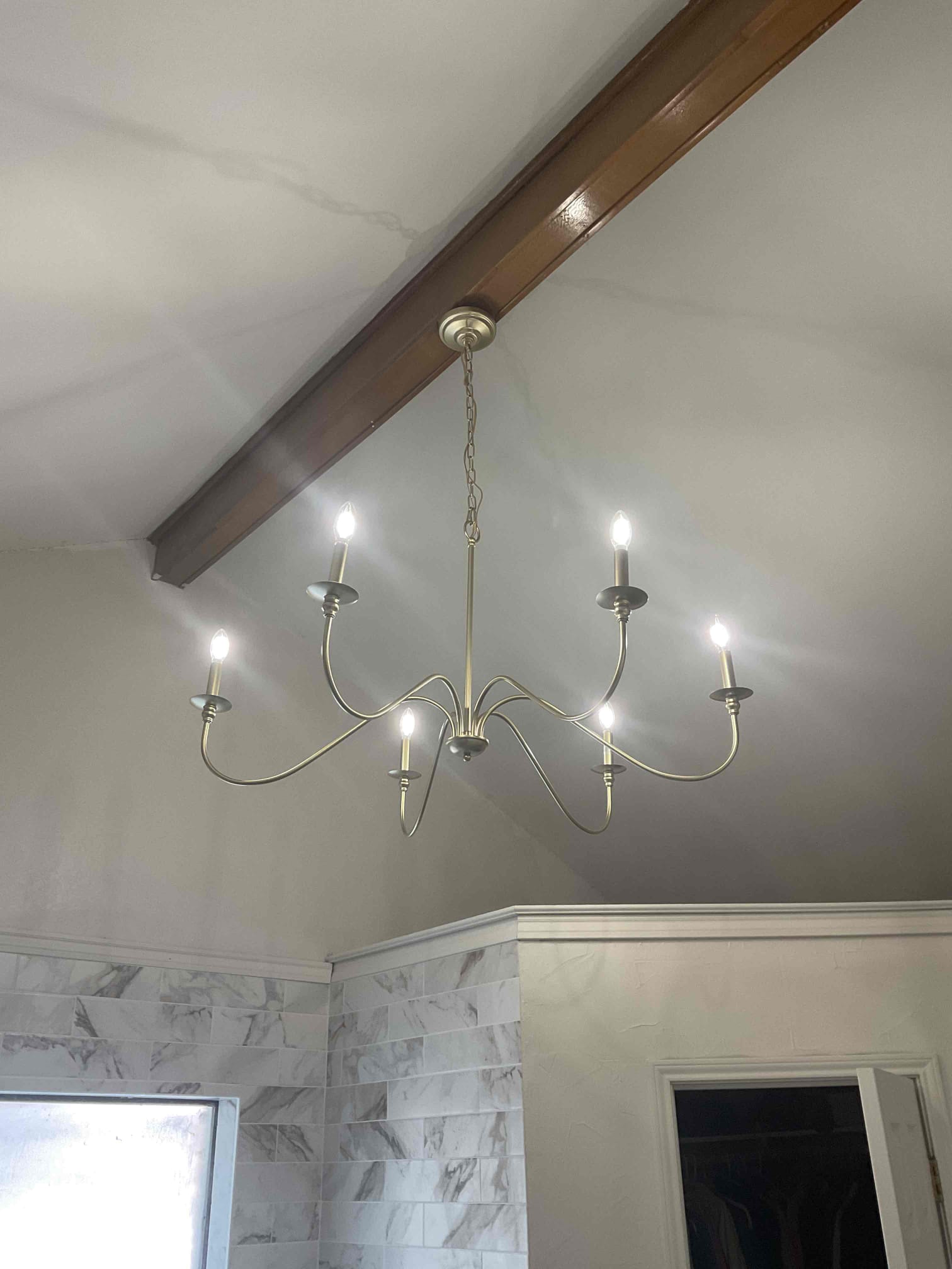 Arrived on job site; customer stated that the chandelier in the master restroom made a loud popping sound from the canopy area. Afterward, he noticed that the breaker had tripped. He reset the breaker, but the light still did not come back on. He then tried swapping the switches with no success and decided to call us out to diagnose the issue.

Performed a minor troubleshooting service and found that the wiring above the fixture was burnt and melted. Discovered that there was no electrical box protecting the wire, so we installed a pancake box on the beam for proper support and protection. put the old chandelier, re-spliced the wiring, and verified that everything is now working properly.

Offered to perform a full safety evaluation, but the customer declined. Noted that the electrical panel was replaced in March and that the home has been re-deviced as well with new grounding system , surge protection, smoke detectors, and GFCIs—all properly installed and in the correct locations.

Cu