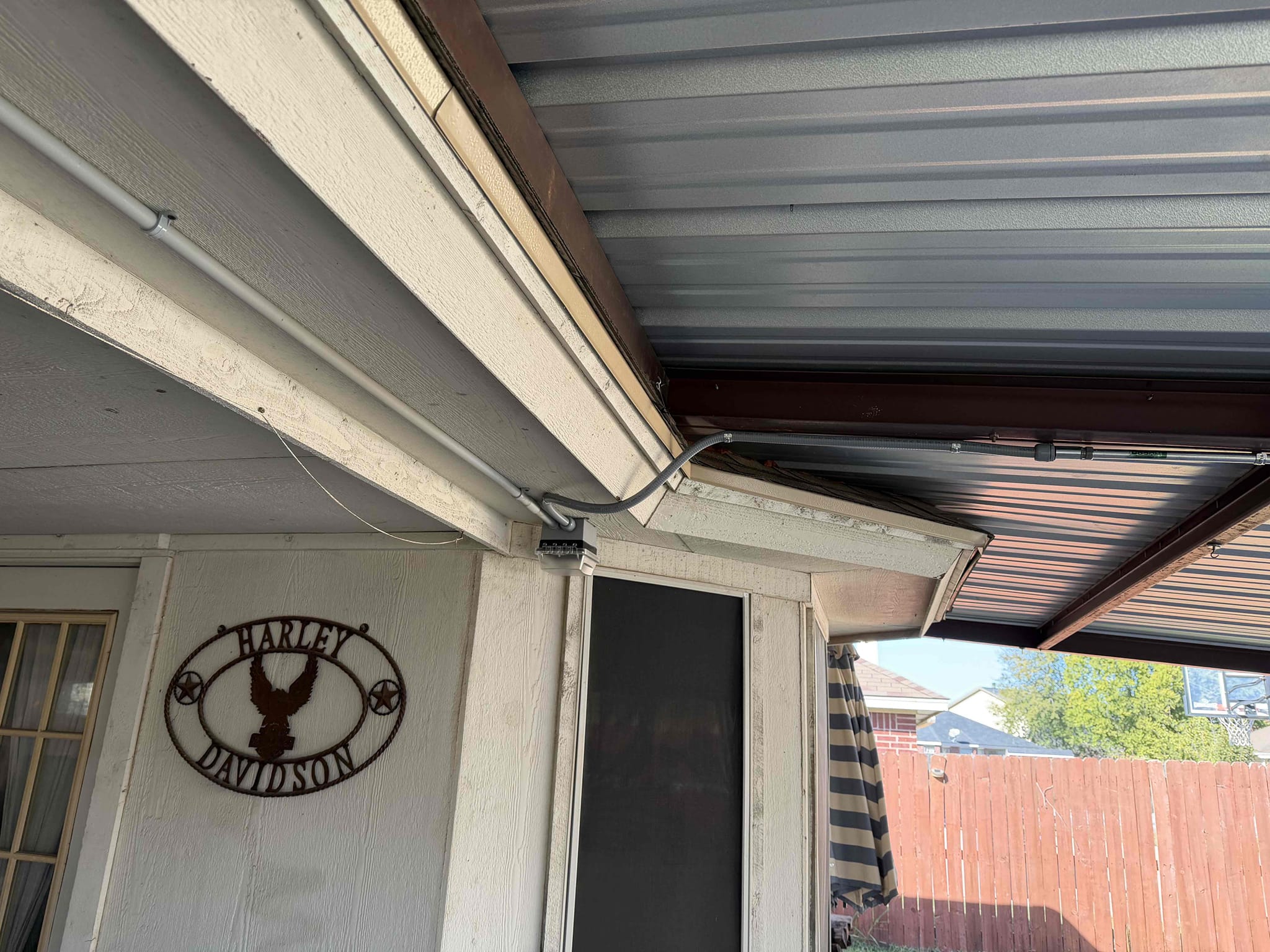 Replace and troubleshoot gfci with cover and siliconed box.
 *5 year warranty only on gfci* 
1. Install whole home surge protection (lifetime warranty) 
2. Install 2 plugs in the back yard 
3. Run conduit In patio 
4. Intermediate troubleshooting in backyard 

*5 year warranty minimum* 

Extended existing soffit outlet circuit to other side of covered patio and ran conduit to two new outlets.  Installed whole home surge protection, and installed slim 2 pole 20 for pool pump and outlets that are sharing neutral.  