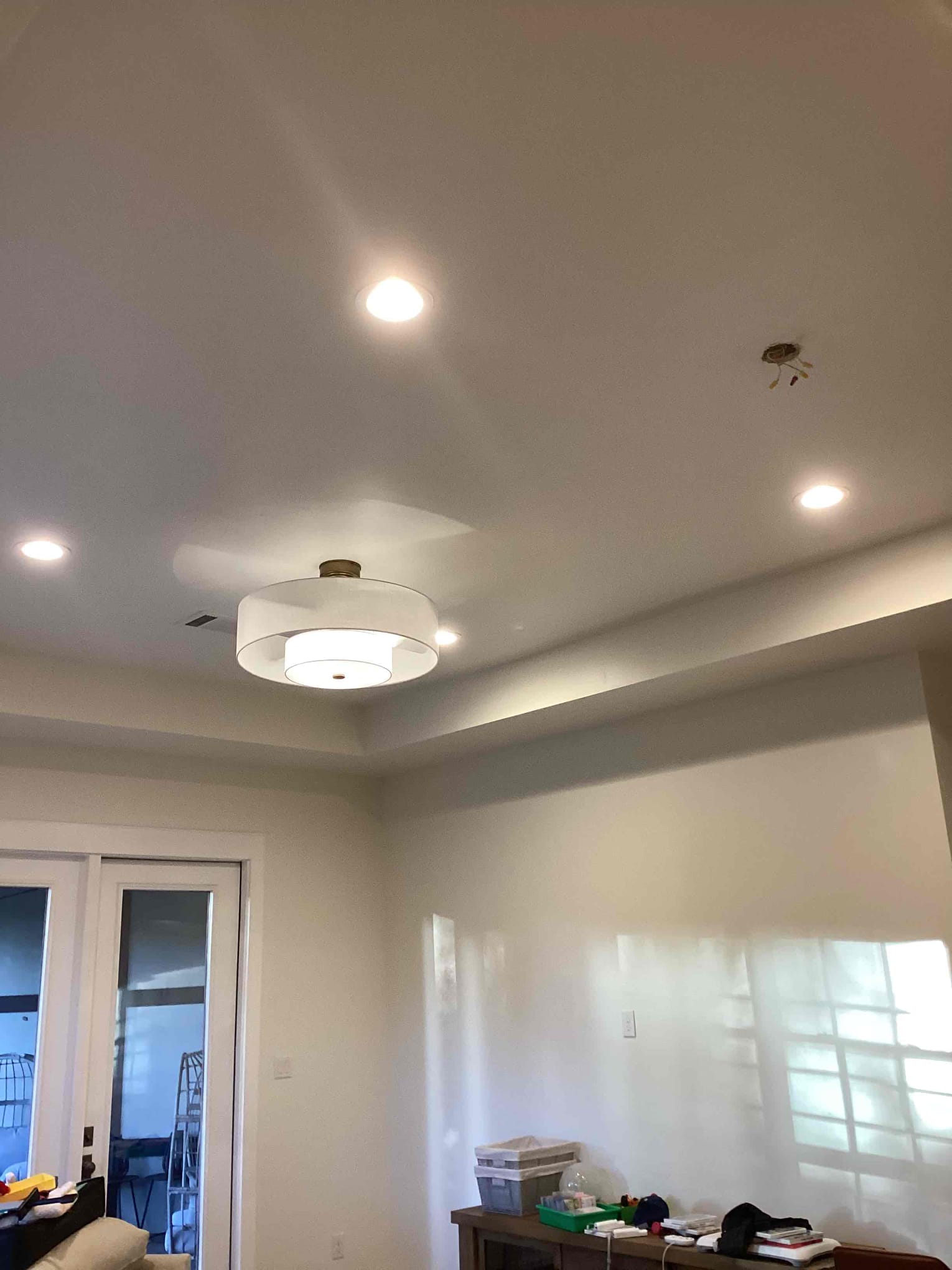 Arrived to warranty the outlet at the top of the stairs as it lost power after an outlet was removed previously by us. Through investigation I found that the neutral behind the outlet around the corner had been capped off and the hot was left energizes. Rewired the back of the outlet box so the correct wires were capped off and the wires needed were energized. While there the homeowner also had two fandelier to install so I mounted those as well.