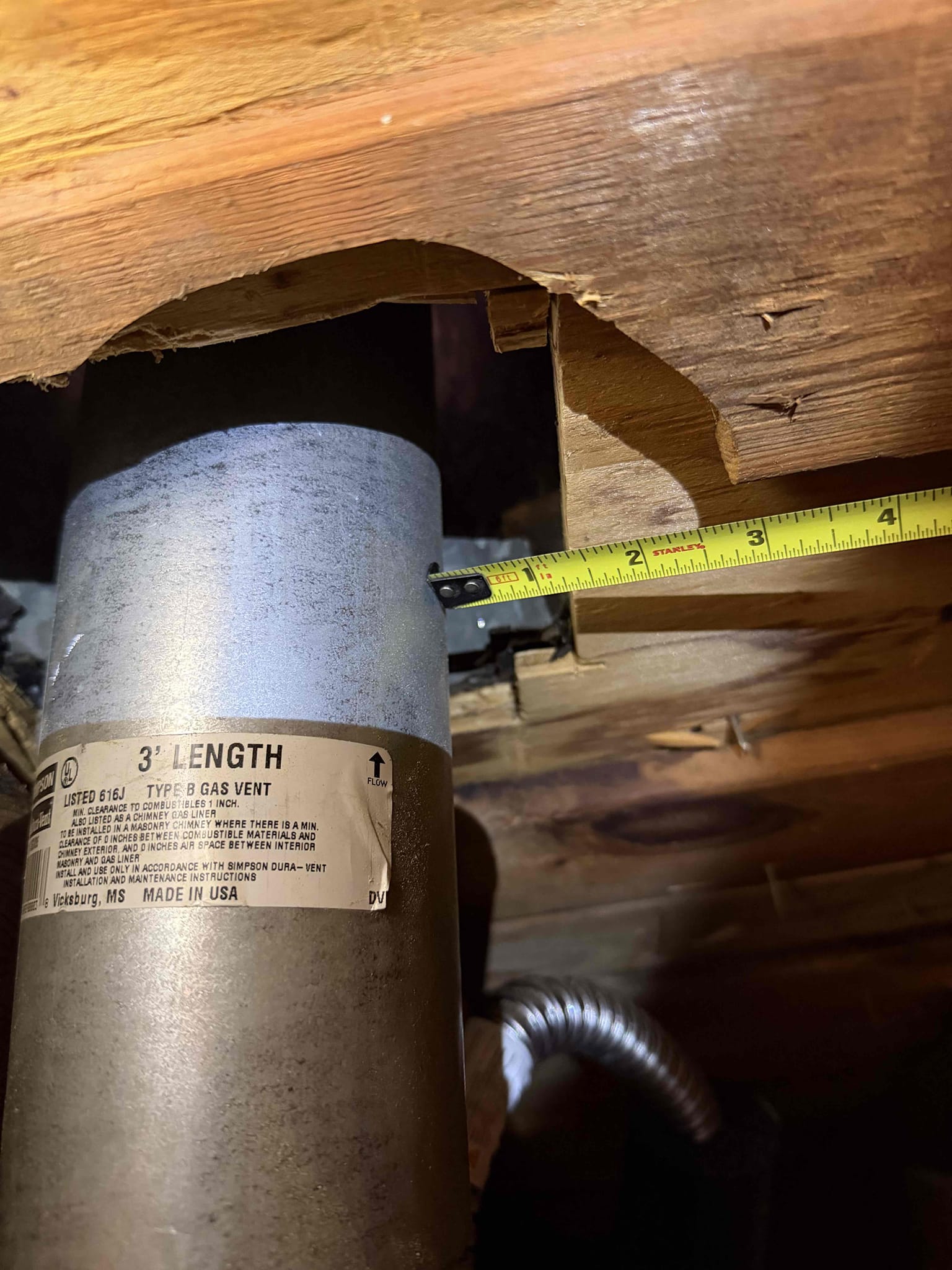 Warranty create clearance for water heater flue piping. 