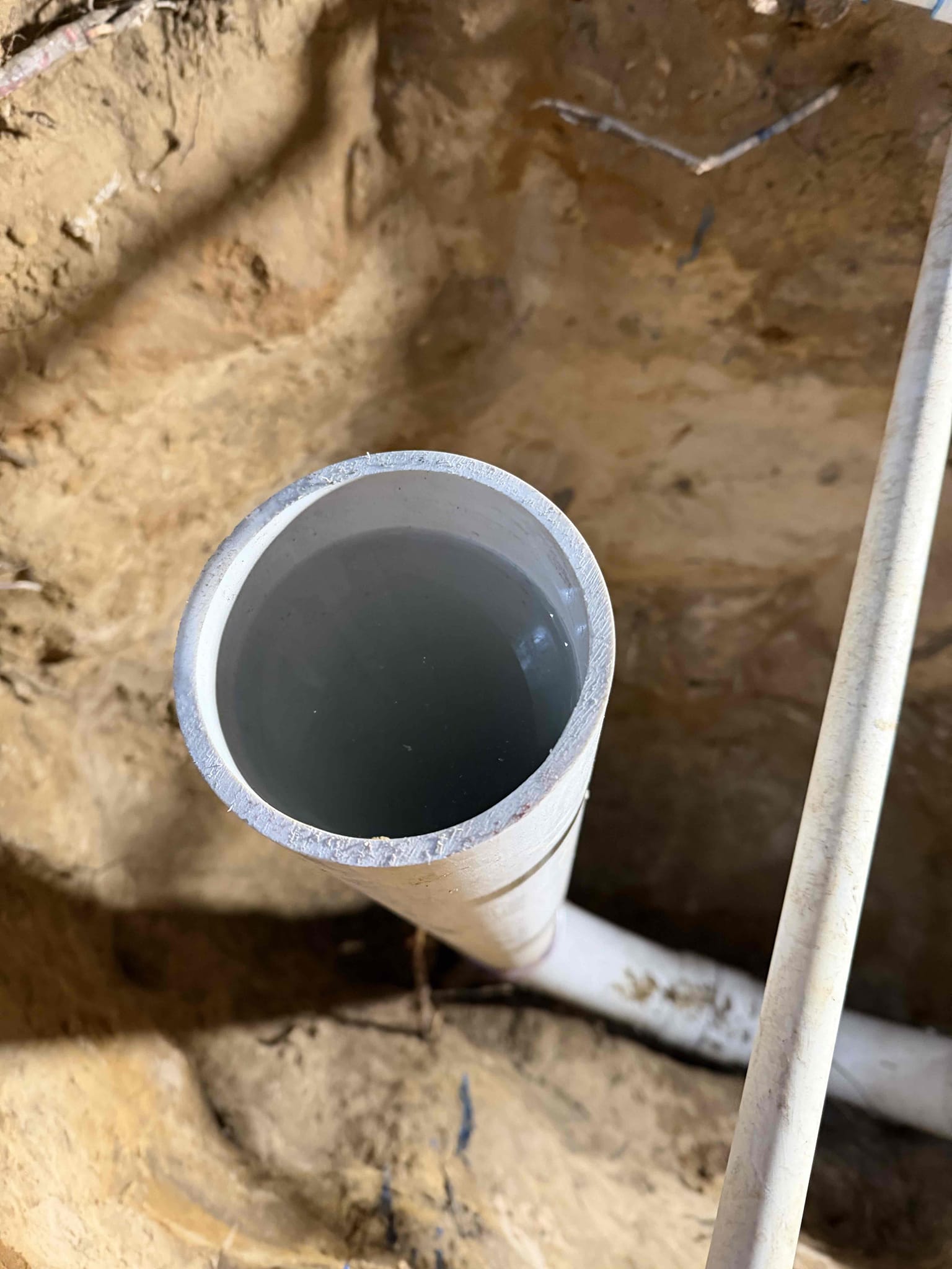 Client called regarding a backed-up sewer system. This is not the first occurrence of this issue. The client reported that other plumbers have previously addressed the problem. Approximately one year ago, during a similar backup, a plumber accessed the roof to cable the line and ran a camera inspection, which revealed the sewer pipe was compromised at the city connection. The homeowner contacted the city at that time, and although the city responded, no repairs were made.


Last night, after a shower was used, the homeowner heard gurgling sounds in the bathrooms and suspected the sewer line was backing up again. This morning, the homeowner’s wife started a load of laundry before leaving the house. When the homeowner later went to use the bathroom, the master bathroom shower had overflowed, causing flooding in that bathroom.


There are accessible cleanouts located at both the laundry and kitchen drains, but nothing directly into the mainline. The plan is to set up the cable machine in 