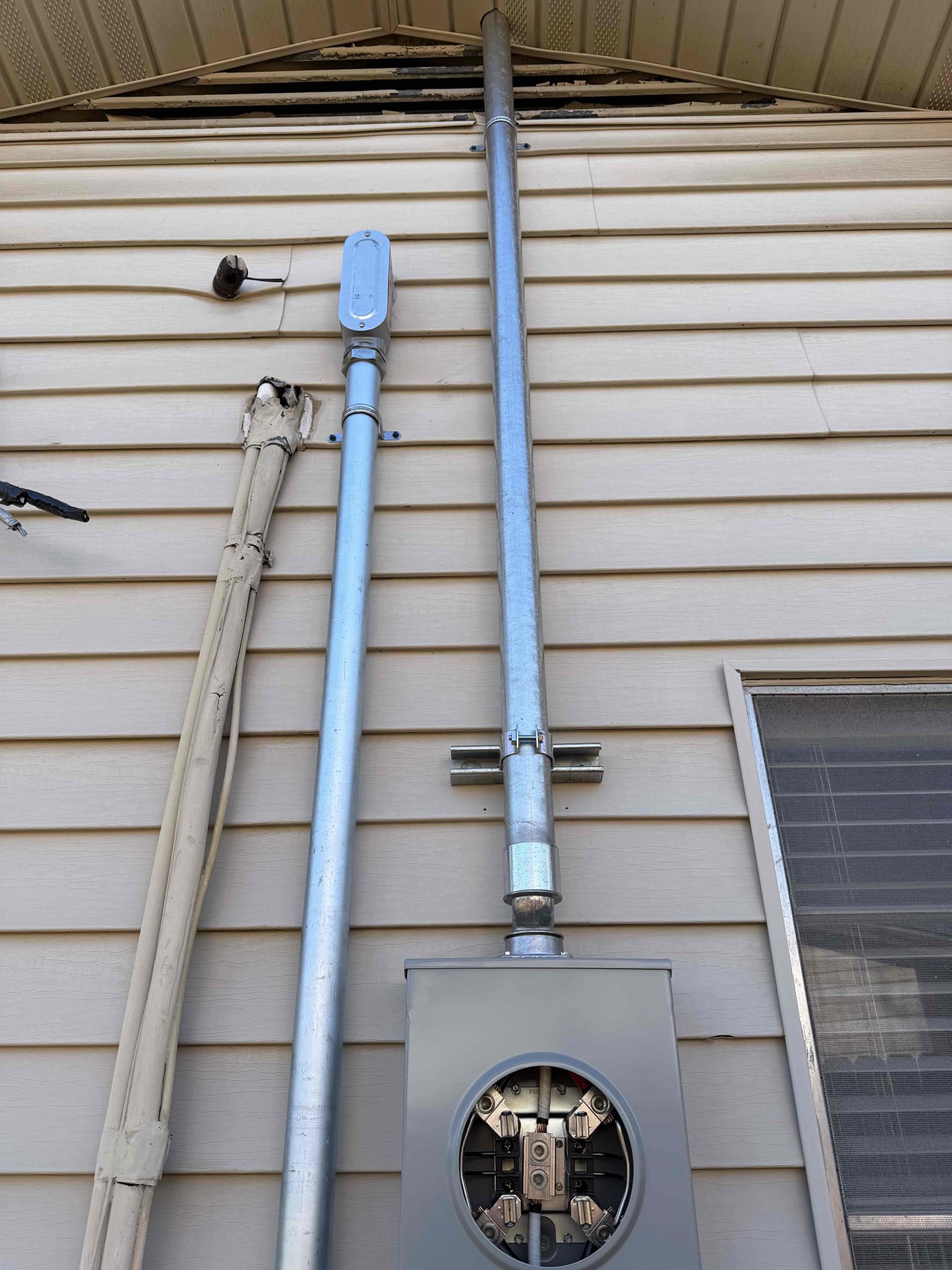 1. Replace electrical panel 125 amp (lifetime warranty) 
2. Relocate electrical panel outside 
3. Replace outdoor meter base overhead (lifetime warranty) 
4. Install cold water bond for copper lines
5. Install ground rod 8ft copper
6. Install hardwired smoke detector in bed/ hall 
7. Install install 5 GFCI outlets in required locations (3 Free)
8. Install whole home surge protection (lifetime warranty) 
9. City permit and inspection 
10. Install chandelier in dining room - (FREE)


*$220 charge for disconnect and reconnect from oncore*
*minimum 5 year warranty on everything* 
*10% discount for 1 year (electric and plumbing)*

Replaced and relocated panel from closet to outside and installed junction box in attic.  Replaced overhead service and properly grounded home with ground rod and cold water bond.  Installed hardwired smokes and gfci protection in all required locations.  Installed whole home surge protection on panel.
