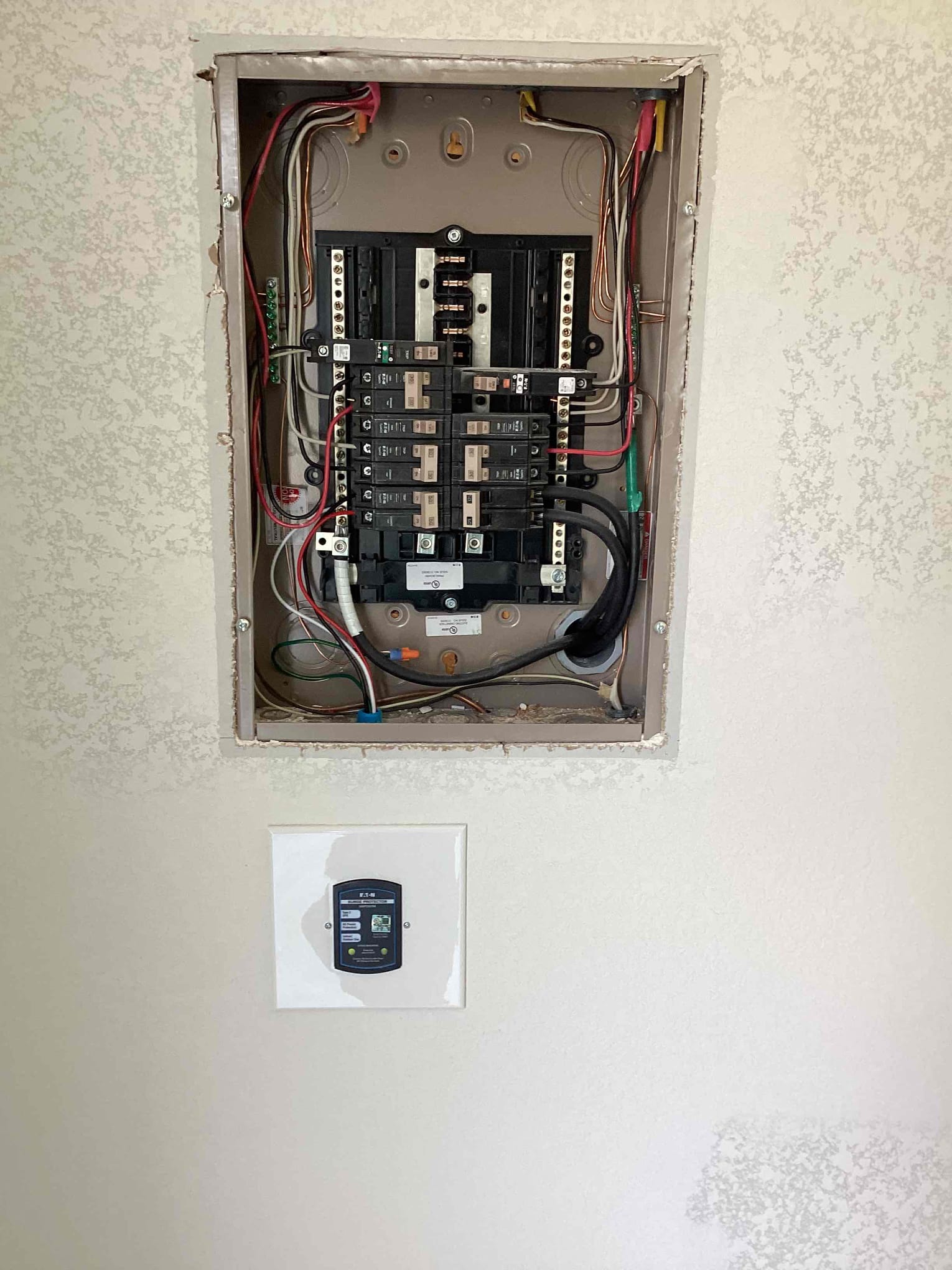 Homeowner had gotten approval from city to have the cooktop that we initially ran a circuit for but had disconnected in the attic for time being. Also found that the second surge was missing as last time the Sheetrock was not installed. Warrantied the breaker and installed surge protector to finish the installation.