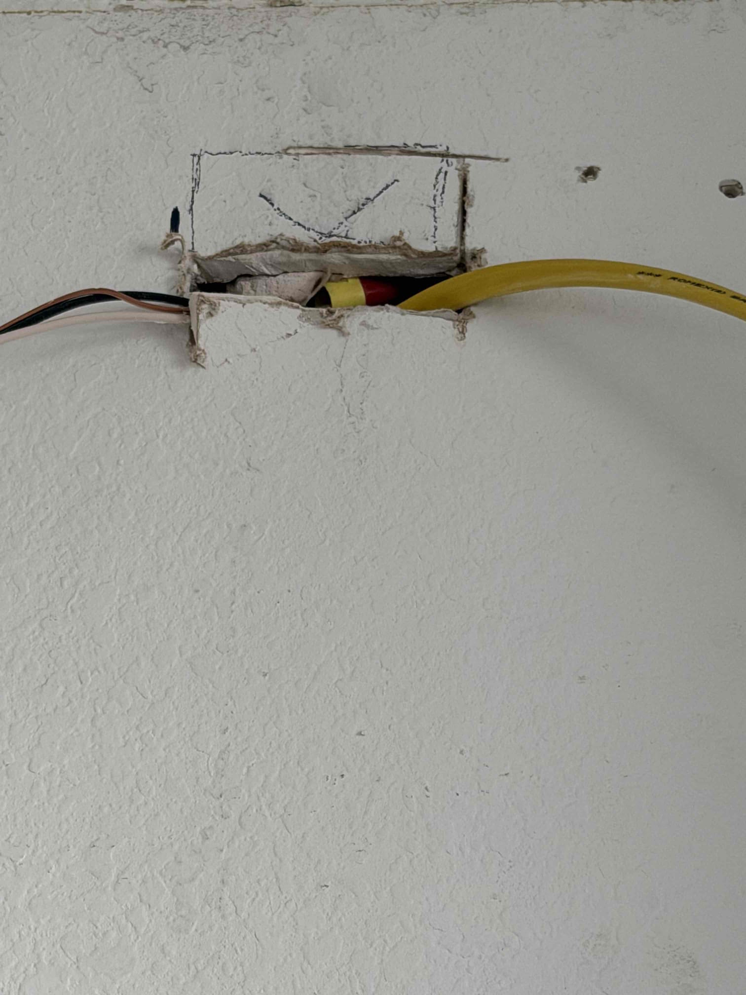 Returned and moved outlet from wall and ran wire up to new location set by ventihood installers for a hardwired installation.  Customer will be calling back once final cabinet is installed 