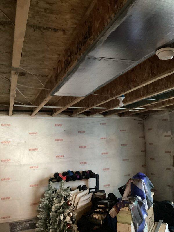 Conducted assessment of unfinished basement requiring electrical work. Evaluated space for installation of approximately 8 new outlets and bringing 2 existing outlets up to code. Documented requirements for recessed lighting throughout basement and sconce fixtures in bathroom area. Basement currently has exposed framing with visible electrical wiring hanging from joists, requiring complete wiring solution before finishing work proceeds.