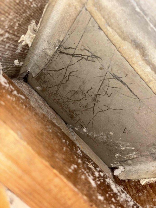 Responded to heating system operating intermittently with warm air output issues on a one-year-old furnace unit. Upon inspection, identified system overheating caused by restricted airflow due to dirty filter and significantly compromised ductwork. Performed diagnostic pressure testing using digital manometer, measuring static pressure readings of 0.22 inWC, confirming excessive restriction in the duct system. Documented visible ductwork damage and restriction issues in basement installation. Recommended comprehensive duct cleaning service to restore proper airflow and system performance, preventing future overheating conditions and ensuring efficient operation of the heating system.