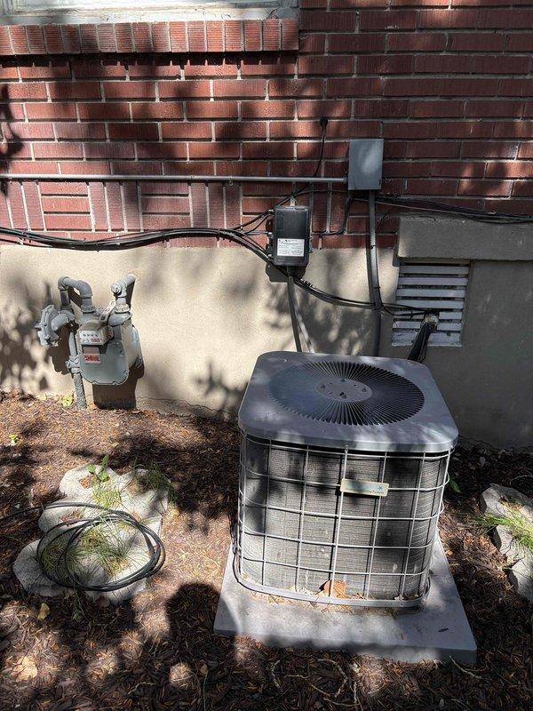 Responded to service call for non-cooling air conditioning system that was found frozen during initial visit and required return after defrost period. Diagnosed 2005 AC unit with R-22 refrigerant leak originating from evaporator coil, resulting in low refrigerant charge and system freeze-up. Provided estimates for refrigerant recharge and evaporator coil replacement, and discussed full system replacement options for aging equipment.
